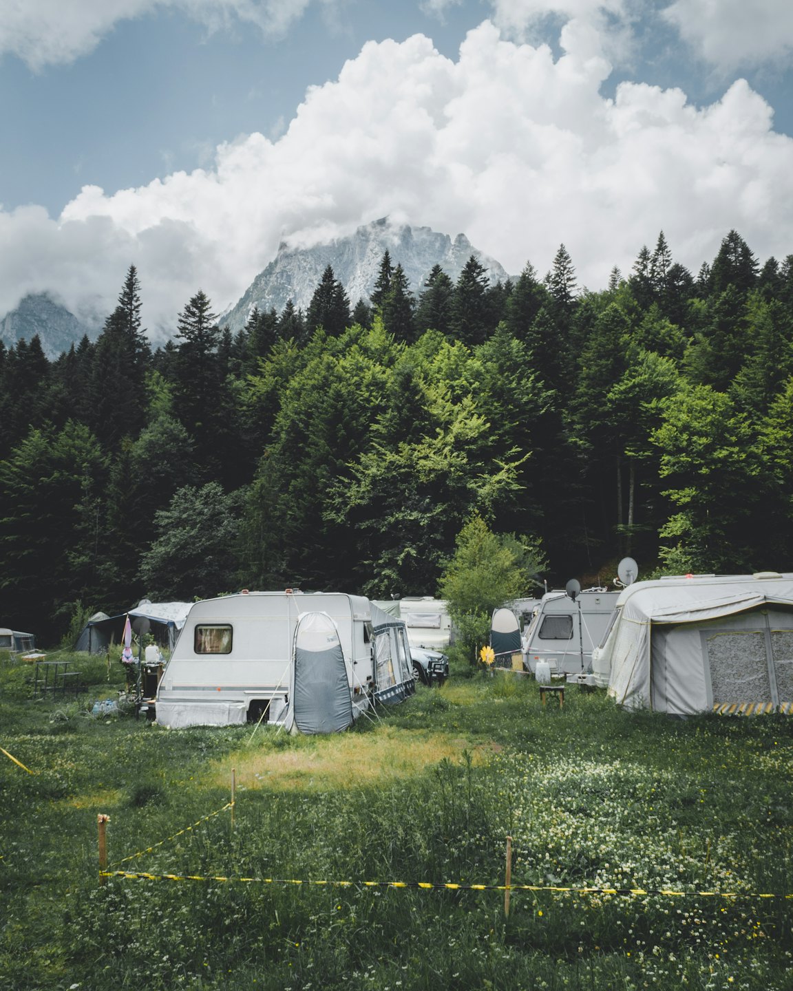 Campground with caravans and tents in a valley.